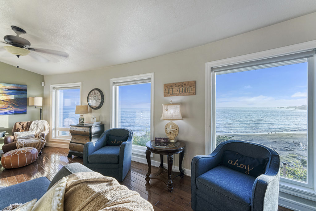 Photo of comfortable seating in living area with windows overlooking the beach at Day Dreamin'