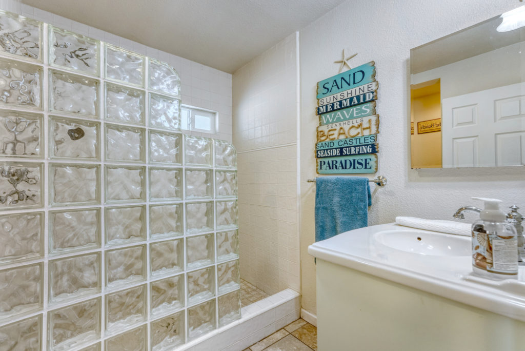 White bathroom with glass block shower at Day Dreamin'