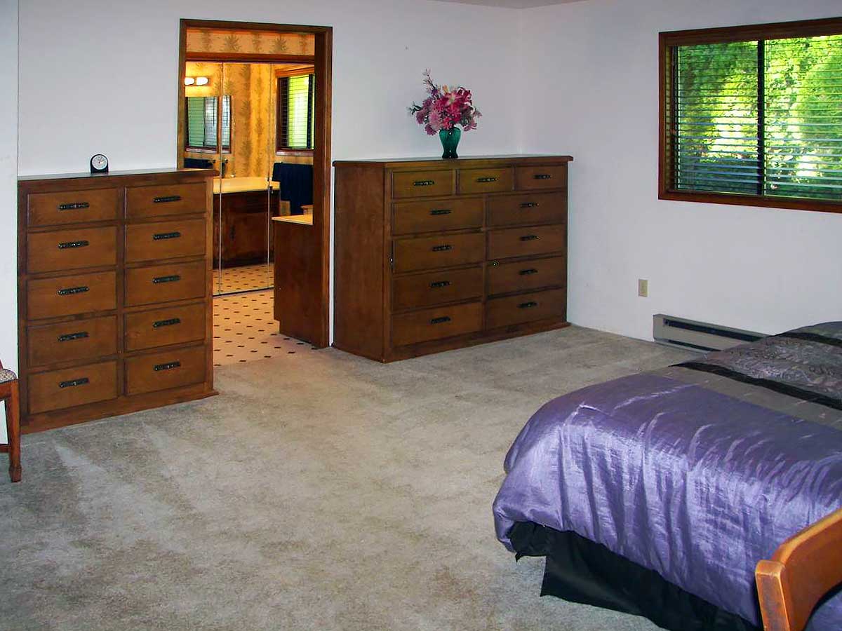 Photo of two large dressers, window, large space with bed and entrance to bathroom at Brookings Serenity