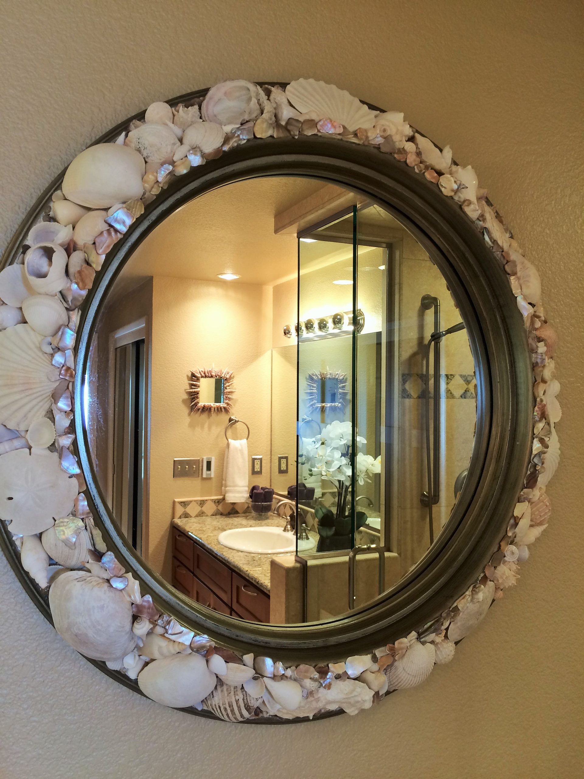 Photo of beautifully framed mirror showing gorgeous bathroom at Pacific Edge