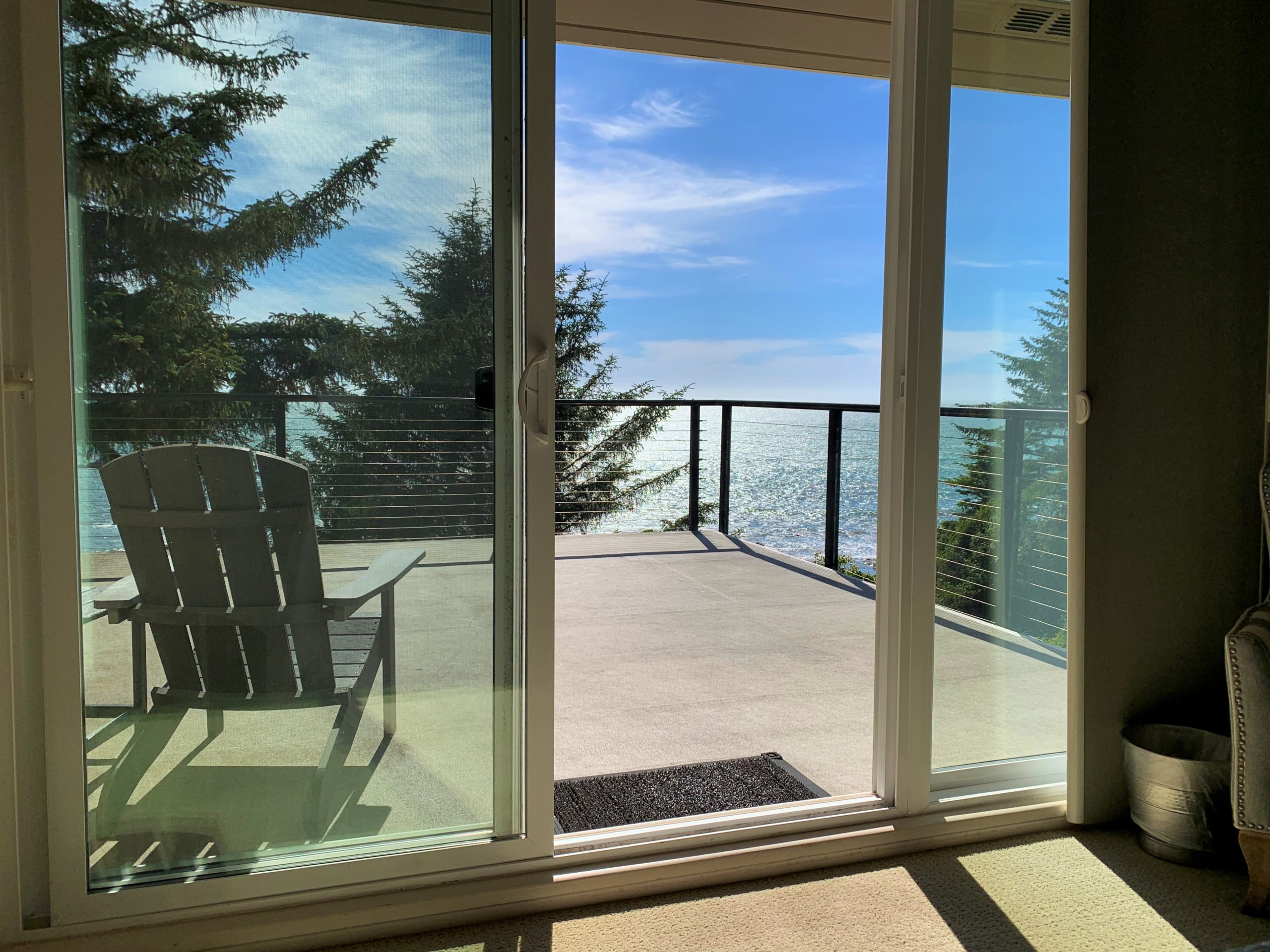 Photo from inside of bedroom to balcony overlooking the ocean at Pacific Edge