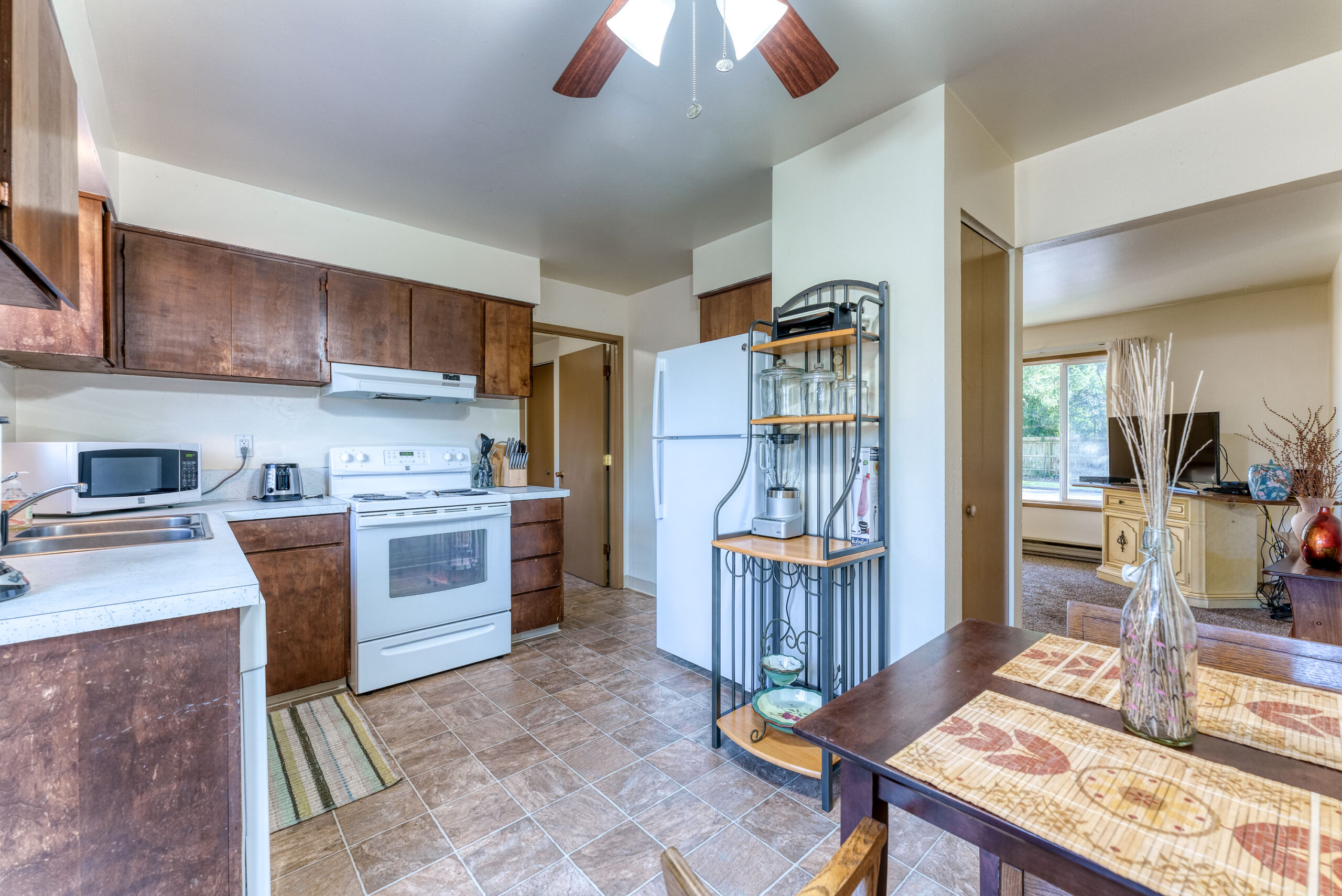 Bright kitchen with sliding glass door stepping outside to the fresh air of Brookings Oregon