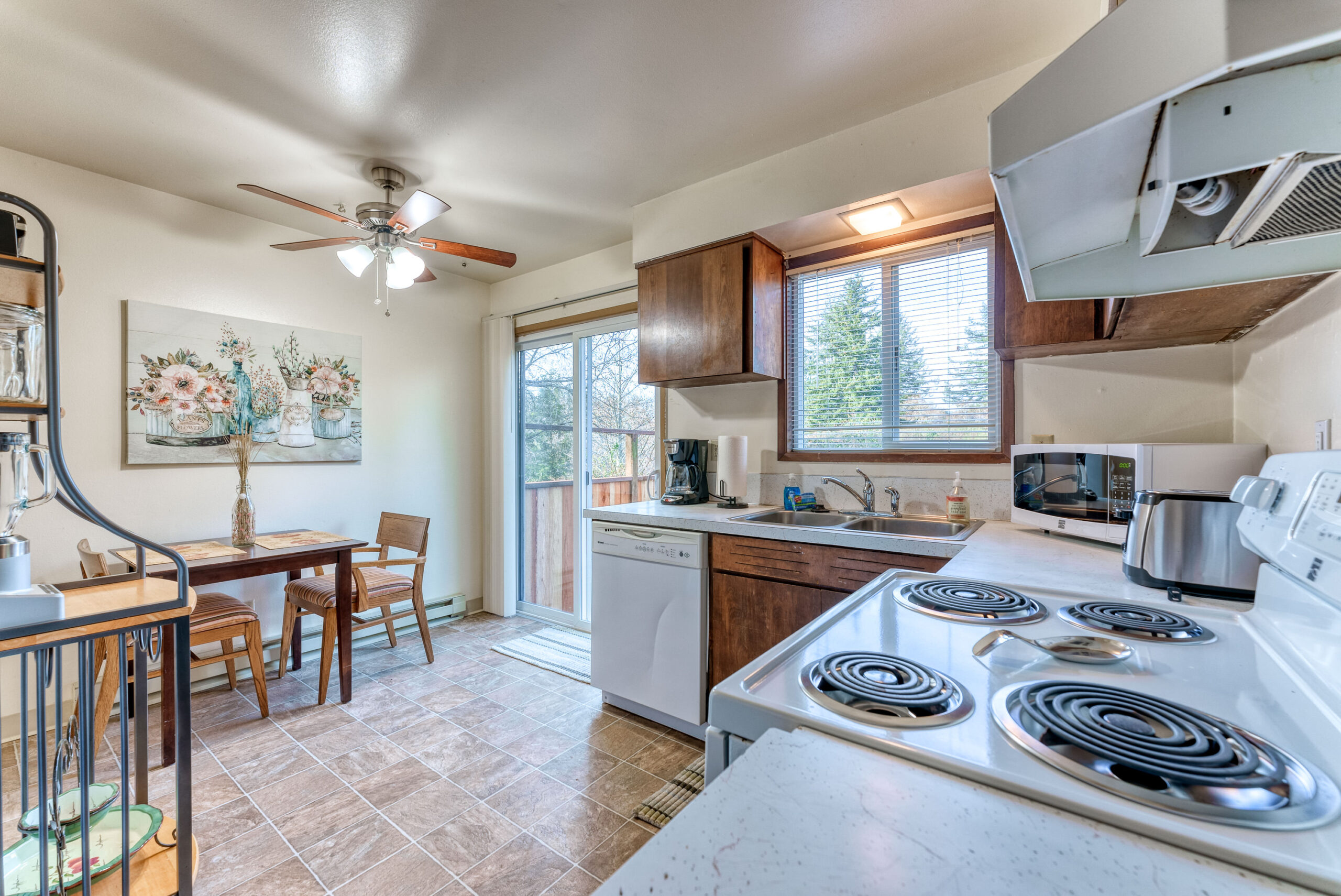 Bright kitchen with sliding glass door stepping outside to the fresh air of Brookings Oregon