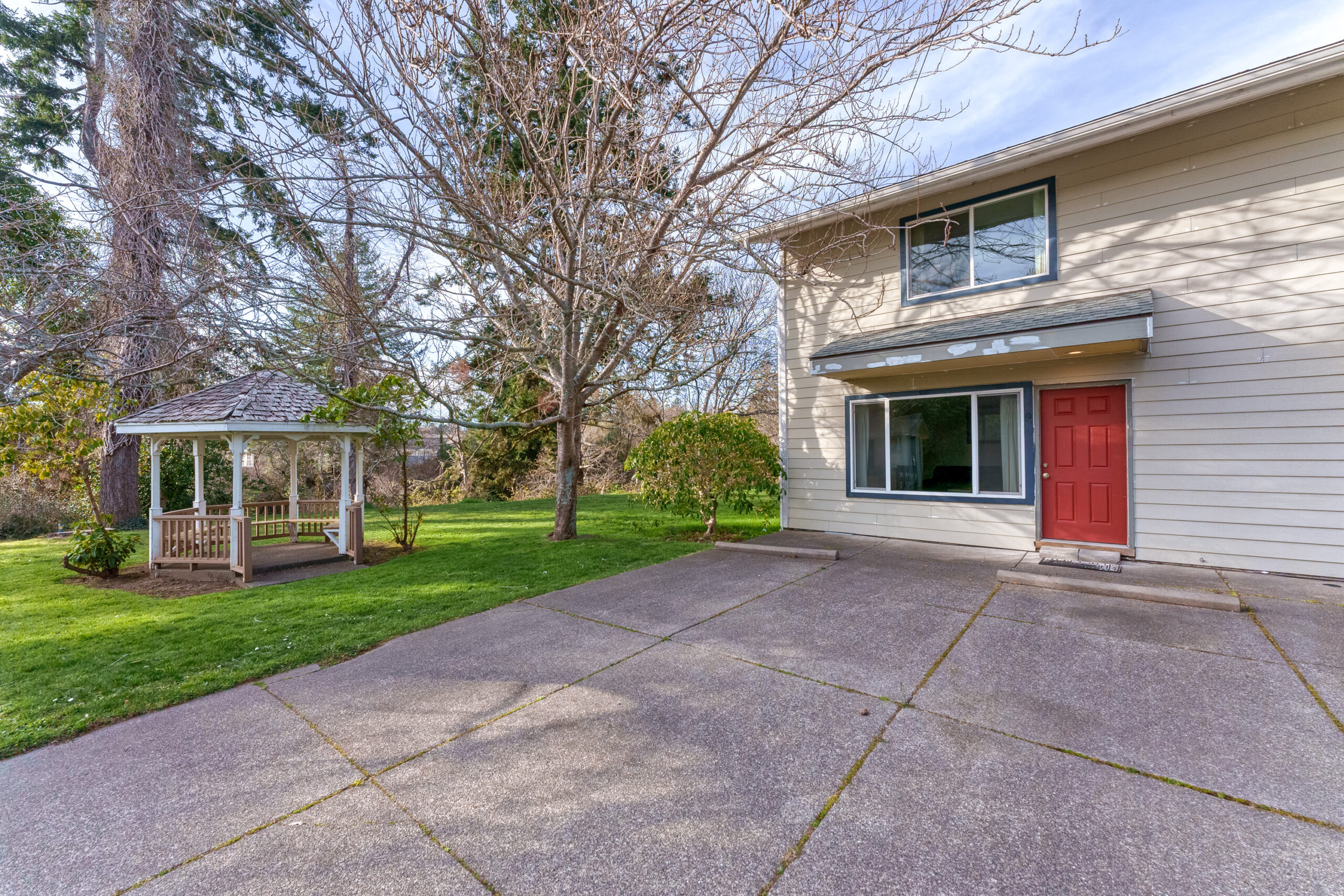 Photo of well maintained yard and concrete drive / entrance to Coastal Cozy Townhome