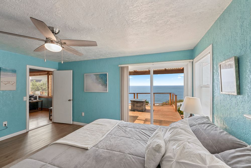 Photo of main bedroom with slider to oceanside deck