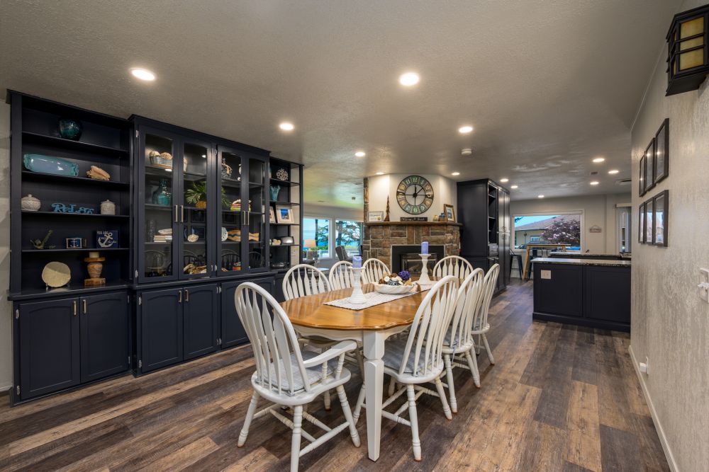 A photo of the great room and dining with two sided fireplace