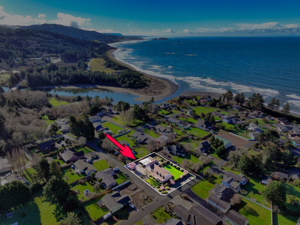 An aerial view of Winchuck River Homestead showing the location of the home as it relates to the river and ocean.