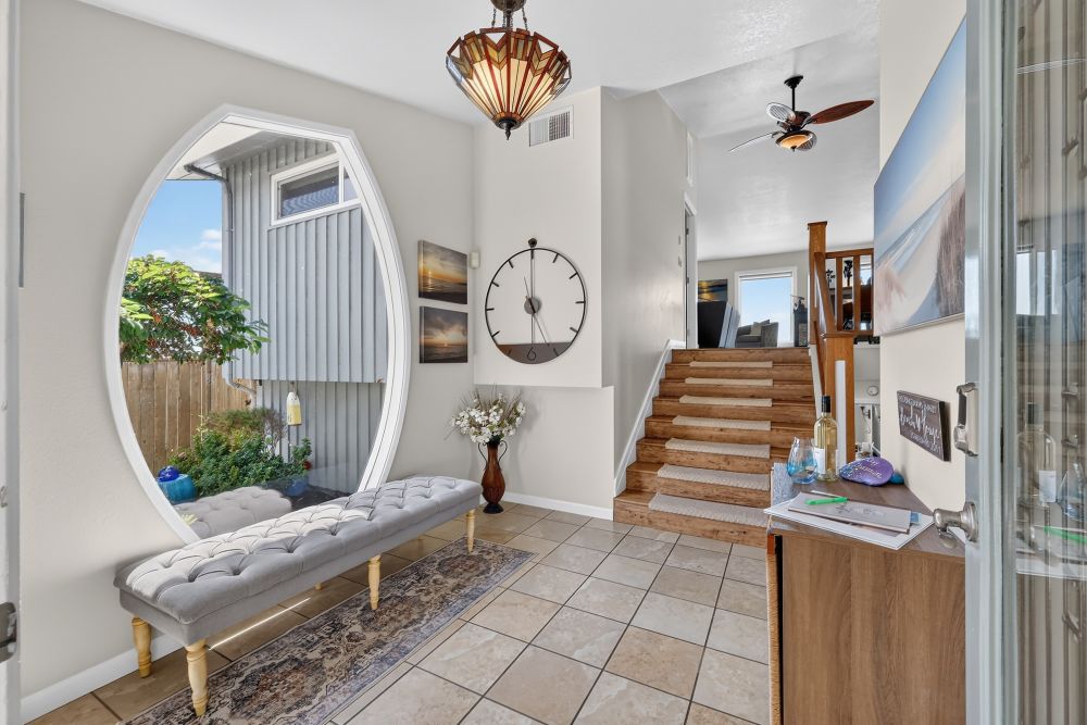 Entryway with huge shaped window and staircase at Day Dreamin', A Brookings Vacation Rental Home