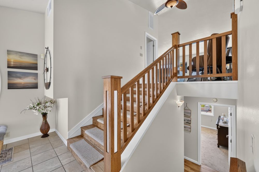 Staircase at entrance leading up to living space or down to bedrooms at Day Dreamin', A Brookings Vacation Rental Home